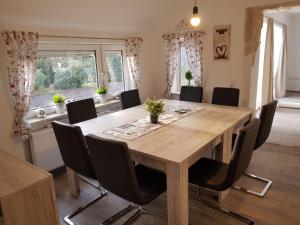 ein Esszimmer mit einem Holztisch und Stühlen in der Unterkunft Fehnhaus, Nordsee, Nähe Norddeich in Westermoordorf