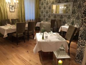 un restaurante con mesas y sillas blancas y un espejo en ZUM ZIEL Hotel & Restaurant Grenzach-Wyhlen bei Basel en Grenzach-Wyhlen