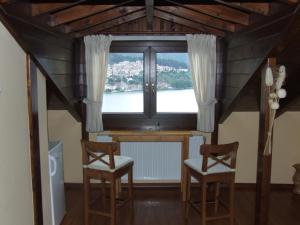 a room with two chairs and a table and a window at Guesthouse Filoxenia in Kastoria