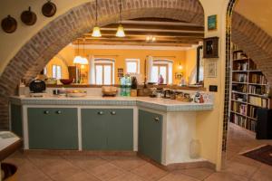 an archway in a kitchen with a sink and a counter at B&B Le Buche Casa Storica in Canino