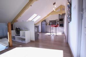 a attic room with a kitchen and a staircase at Appartement Barcelonnette in Barcelonnette