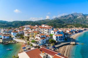 an aerial view of a town on the beach at Green Hill Studios & Apartments in Kokkari