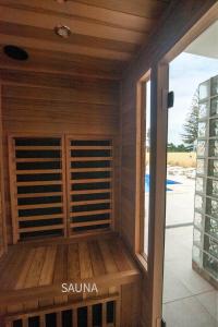 a room with a sauna with a window at villa Aqua-Jacuzzi-heatable pool-sauna-gym-snooker in Albufeira