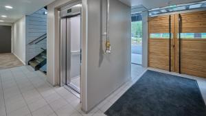 a hallway of a house with a door and a staircase at Naava Chalet First Floor in Ähtäri