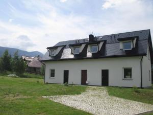 a white house with a black roof at Eol in Karpacz