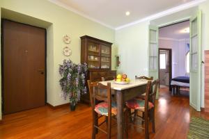 a kitchen and dining room with a table and chairs at il ricamo in Badalucco