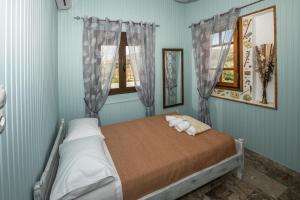 a bedroom with a bed with a stuffed animal on it at House with view in Kissamos in Kissamos