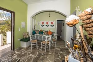 comedor con paredes verdes, mesa y sillas en Kyparissos Apartment I, en Kissamos 8 fotos más