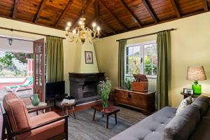 a living room with a couch and a fireplace at Casas do Lanço by An Island Apart in São Vicente