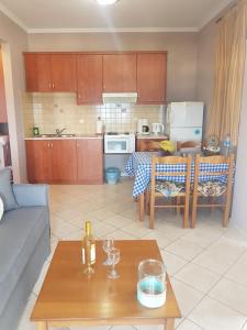 a kitchen and a living room with a table at Evangelia in Karfas