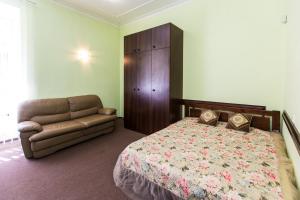 a bedroom with a bed and a couch at Luxury central two bedroom apartment in Lviv