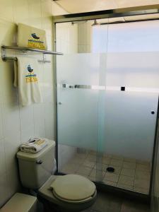 a bathroom with a toilet and a glass shower at Hotel Cuellar in Tula de Allende