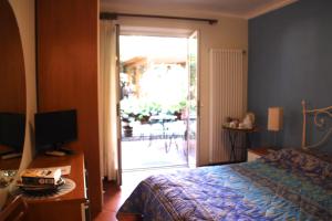 a bedroom with a bed and a sliding glass door at Villa Clelia in Levanto