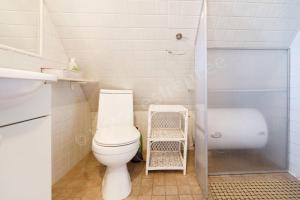 a bathroom with a toilet and a bath tub at Kaju Guesthouses in Nasva +25 photos