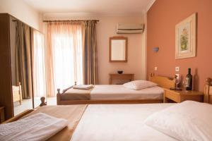 A bed or beds in a room at Atira Apartment Hotel
