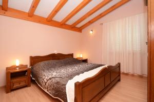 a bedroom with a bed and two night stands at Villa Silva in Vela Luka