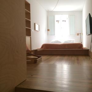 a bedroom with a bed and a window at SOBRE RIBAS 2|12 in Coimbra