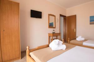 A bed or beds in a room at Atira Apartment Hotel