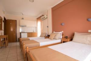 A bed or beds in a room at Atira Apartment Hotel