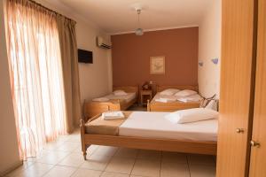 A bed or beds in a room at Atira Apartment Hotel