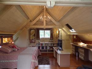 a bedroom with a large bed in a attic at Moulin du soustre in Cavagnac +154 photos