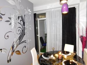 a dining room with a table and a mirror at Velvet Lux in Niš