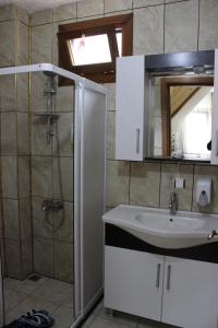 a bathroom with a sink and a shower at Uzungol Selale otel Bungalow in Uzungöl +77 photos