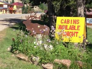 a sign that is on the side of a road at Columbine Cabins in Grand Lake