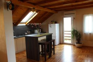 a kitchen with a black counter and a refrigerator at Apartment Ružica in Sukošan