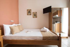 A bed or beds in a room at Atira Apartment Hotel