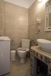 a bathroom with a toilet and a sink at Maistros Holiday Home in Vourvourou