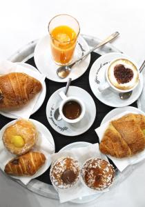 a tray of different types of pastries and cups of coffee at Bed No Breakfast AK 2 in Naples