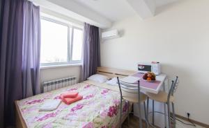 a bedroom with a bed and a table and a window at EasyStay inn in Kyiv