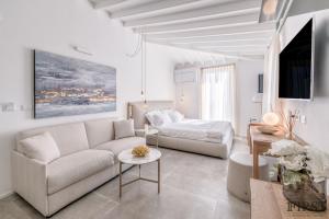 a white living room with a couch and a table at Il Sogno di Manarola by The First in Manarola