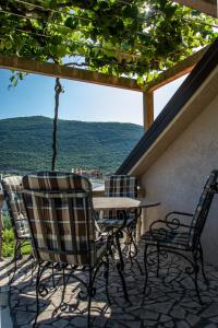 a table and chairs on a patio with a view at Apartmani Mendula in Budva