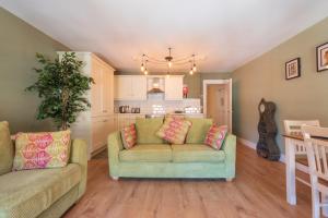 a living room with a couch and a kitchen at Diamond House Apartments in Derry Londonderry