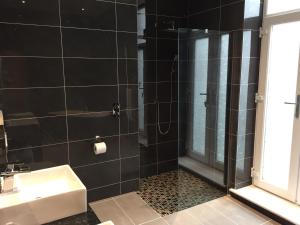 a bathroom with a shower and a sink at Halvard Hotel in Douglas
