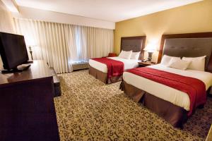 Ein Bett oder Betten in einem Zimmer der Unterkunft Grand Oaks Hotel