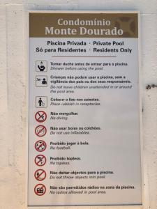 a sign on the side of a building withbidden signs at Cardoso Beirao in Carvoeiro