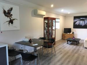a living room with a dining room table and chairs at killarney barn in Petersfield