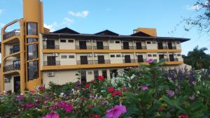 a building with flowers in front of it at Hotel Da Vila in Joinville