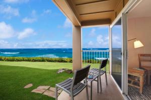 a patio with a view of the ocean at The ISO in Kapaa