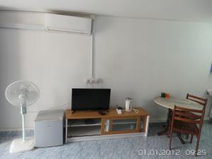 a living room with a table and a chair at RL Budget Rooms in Pantai Cenang