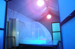 a room with a bed in a tent with lights at Kottawatta Village in Udawalawe