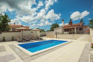 a swimming pool in the backyard of a house at Villa Paola in Vodnjan