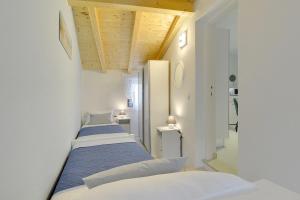 a row of beds in a room with white walls at Villa Paola in Vodnjan +73 photos