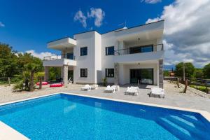 an image of a villa with a swimming pool at Apartments Residence Romance in Pinezici