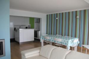 a living room with a white couch and a table at Zeedijk 241, uitzicht op zee, vue sur la mer in Koksijde
