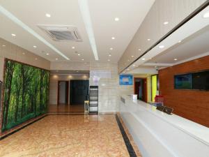 a lobby with a large painting on the wall at Vatica Shanghai Jinshan District Jinshan International Trade City Weihong Road Hotel in P'ai-ts'ang +7 photos