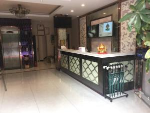 een lobby met een bar in het midden van een kamer bij GreenTree Alliance Shanghai Minhang District Hongqiao Hub Huanghua Road Hotel in Shanghai